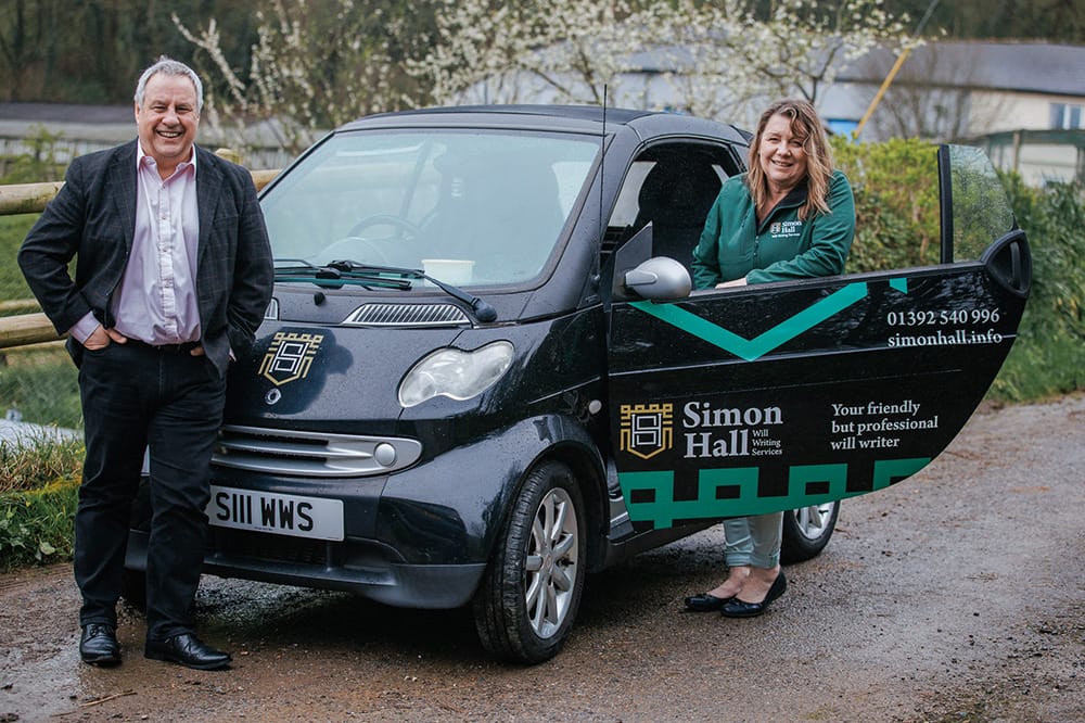 LPA-Image-2 Simon and Linda standing with a branded Smart Car